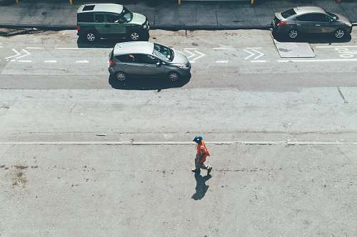 united states person walking on road near vehicles at daytime new york